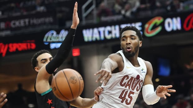 Jan 5, 2024; Cleveland, Ohio, USA; Cleveland Cavaliers guard Donovan Mitchell (45) passes against Washington Wizards guard Tyus Jones (5) during the first half at Rocket Mortgage FieldHouse. Mandatory Credit: Ken Blaze-USA TODAY Sports